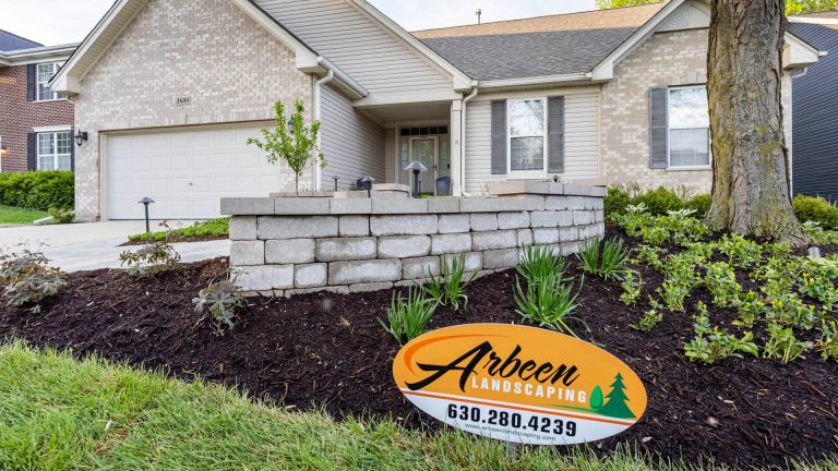 Arbeen Landscaping project. Retaining wall and mulch beds enhance curb appeal. Residential landscaping design.