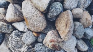 Pile of smooth river rocks. Landscaping stones for backyard design. Decorative rock close up.
