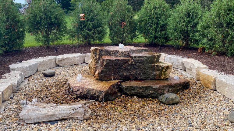 Commercial landscaping: Water feature with stone fountain and rock border.