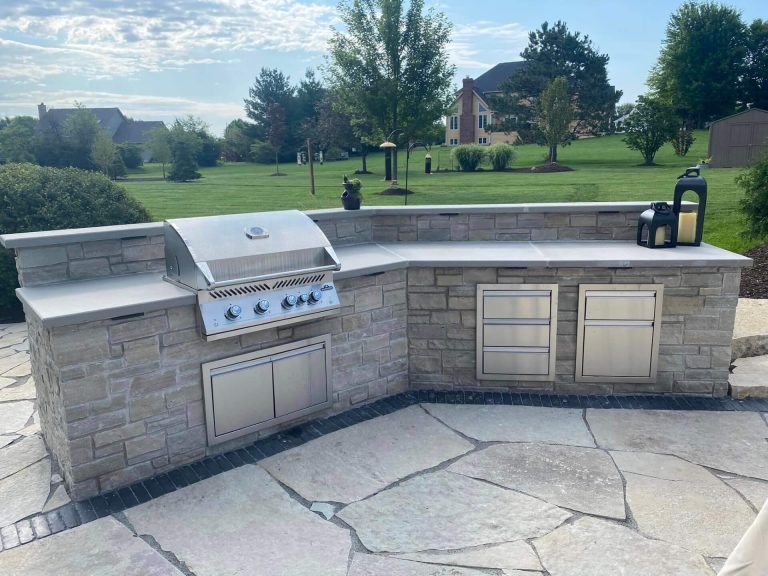 Photo of an outdoor kitchen built within a brick paver patio