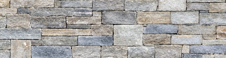 Residential landscaping brick paver retaining wall texture.