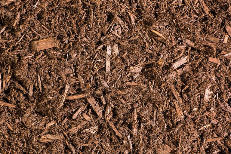 Top-down closeup photo of brown mulch for landscaping
