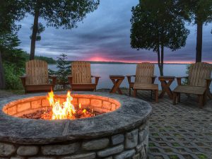 Photo of a brick paver patio firepit at sunset