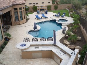 Aerial photo of a dream outdoor kitchen, brick paver patio, and pool