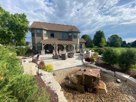 Photo of a backyard with a brick paver patio