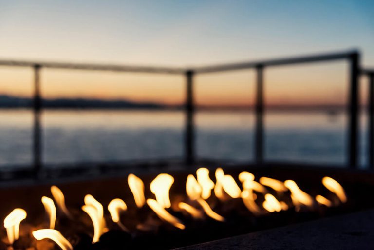 Photo of flames from gas fire pit at sunset