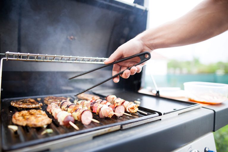 Photo of food being grilled on an outdoor kitchen grill