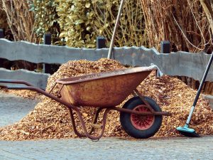 Photo of a wheelbarrel with seasonal mulch for a garden